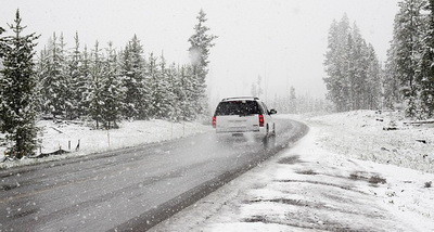 Car driving in winter snow