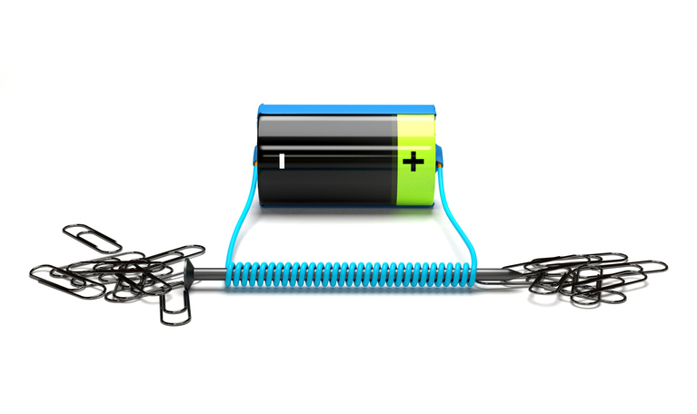 Depiction of a wire wrapped around a nail with the wire connected to a battery creating a circuit and consequently creating an electromagnetic.