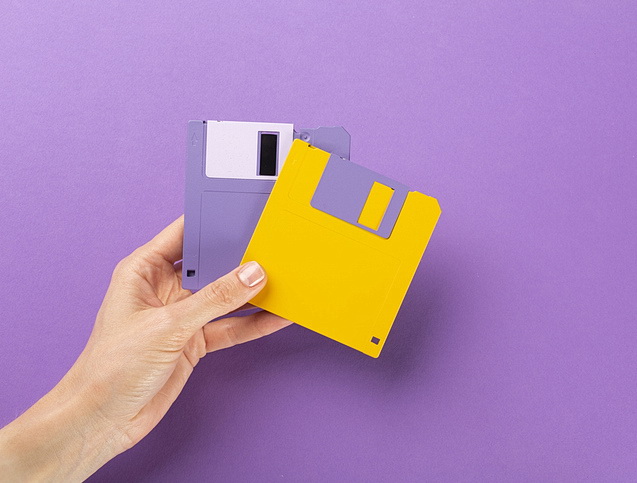 Woman holding two 5.25" floppy disks