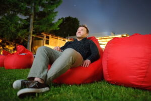 Man in backyard looking at night sky